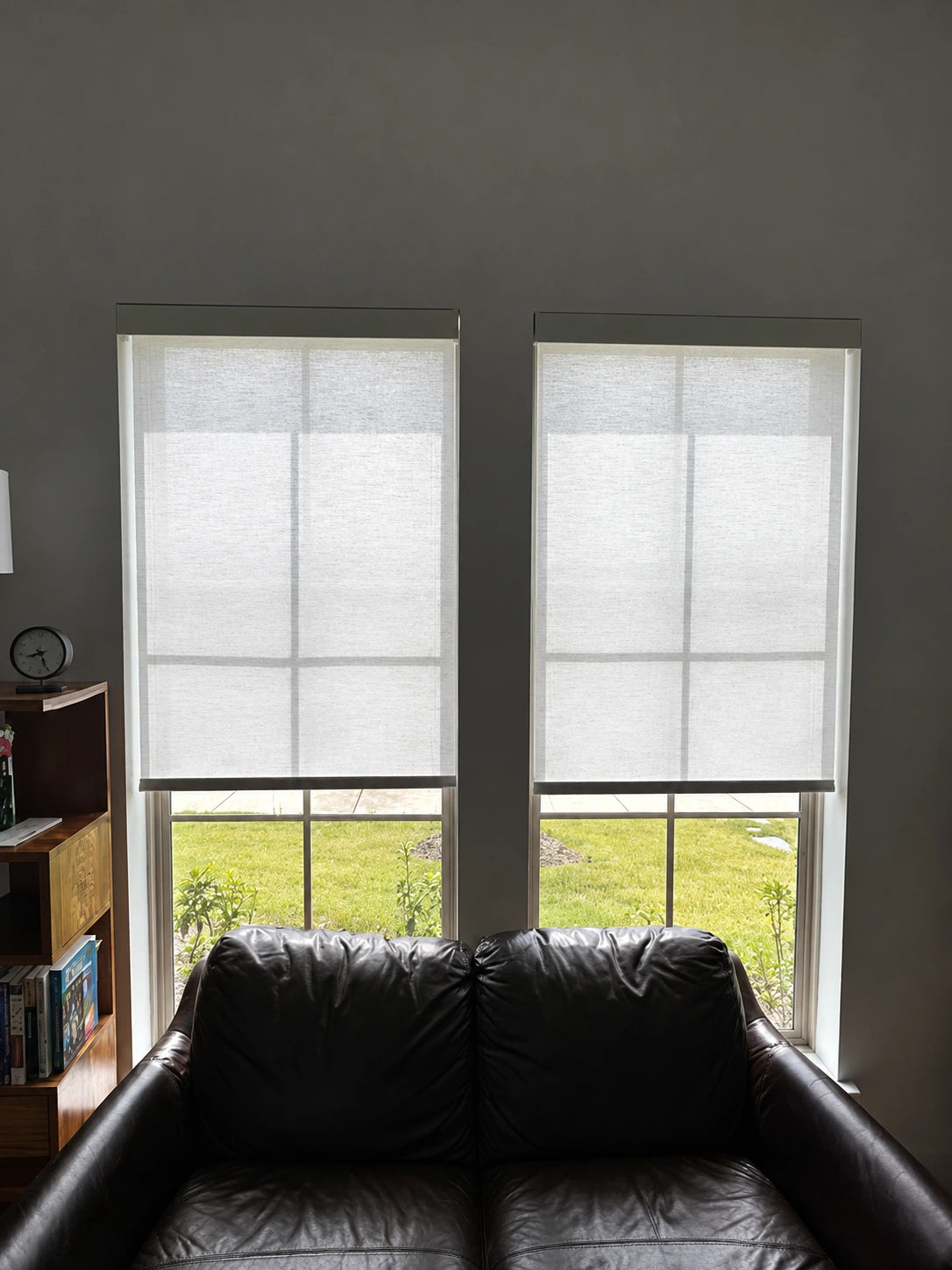 Two windows behind a loveseat